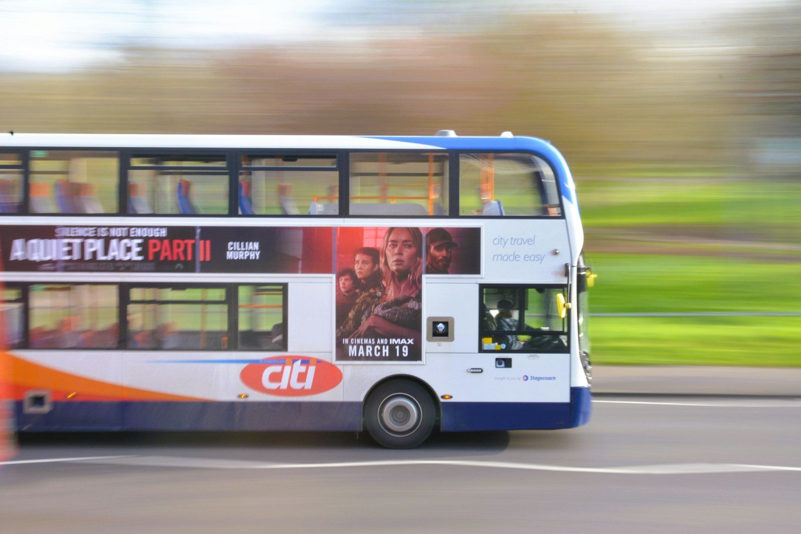 Double-decker bus with ads in motion